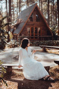 Woman sitting on a tree