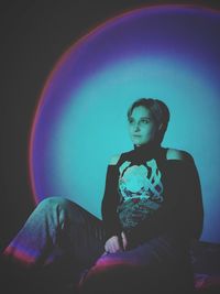 Portrait of woman sitting on sofa at home