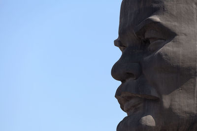 Low angle view of statue against blue sky