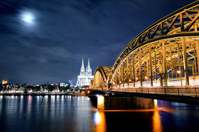 Illuminated hohenzollern bridge and cologne cathedral at night