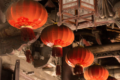 Low angle view of illuminated lanterns hanging in ceiling