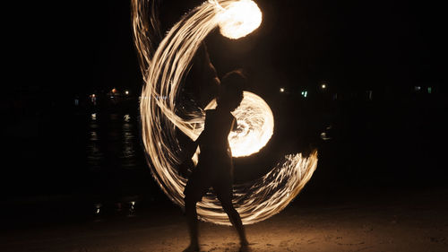 Full length of illuminated woman against sky at night