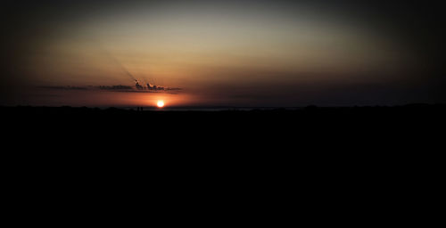 Scenic view of silhouette landscape against sky during sunset