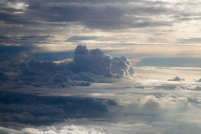 Sunlight streaming through clouds in sky