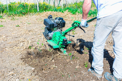 Low section of man working on field