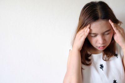 Portrait of woman against white background