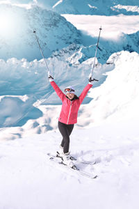 Woman skiing on snowcapped mountain