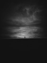 Silhouette of landscape against cloudy sky