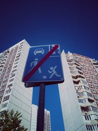 Low angle view of road sign against buildings