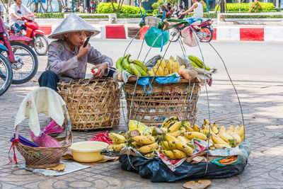 Man sitting in basket for sale at market