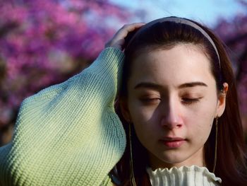 Close-up portrait of a young woman with eyes closed