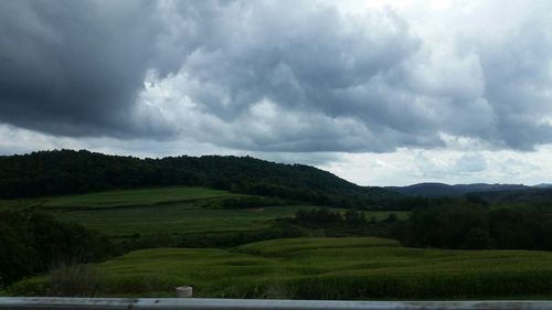 Scenic view of mountains against cloudy sky