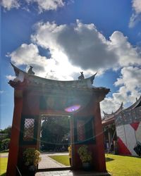 Low angle view of building against cloudy sky