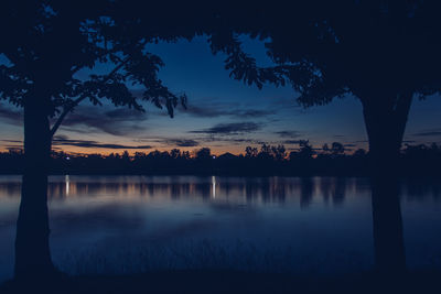 Scenic view of lake against sky at sunset