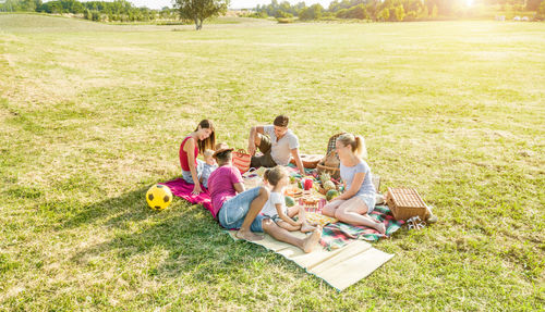 View of family at picnic on field