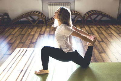 Woman sitting on floor at home