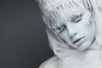 Close-up portrait of young woman with fake snow