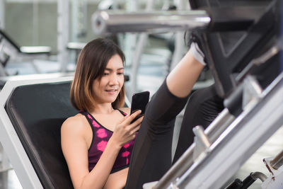 Midsection of woman using mobile phone