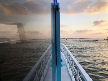 Sailboat sailing on sea against sky during sunset