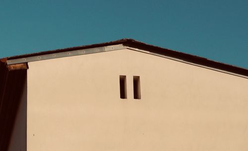 Low angle view of building against blue sky