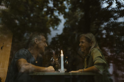 Low angle view of mature couple enjoying candlelight dinner at restaurant