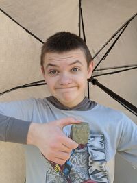 Portrait of boy holding camera