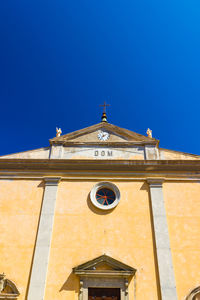 Low angle view of building against clear blue sky