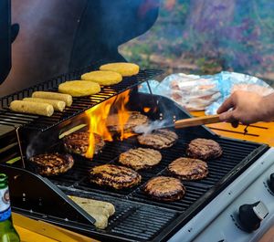 Close-up of person cooking food on barbecue