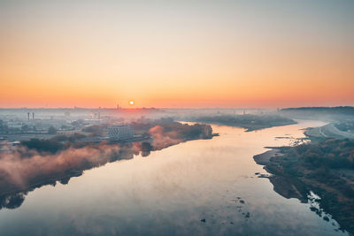 Aerial view of city by river during winter