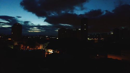 Illuminated cityscape against sky at night