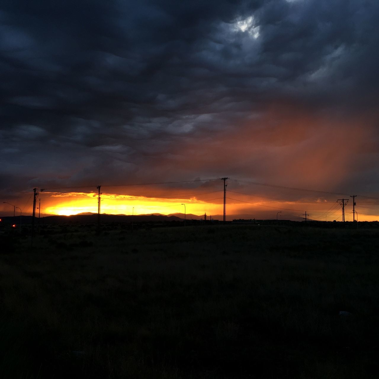 sunset, sky, landscape, tranquility, silhouette, tranquil scene, scenics, beauty in nature, cloud - sky, orange color, field, nature, fuel and power generation, cloudy, dramatic sky, idyllic, electricity pylon, wind turbine, cloud, horizon over land