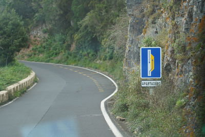 Road sign by trees