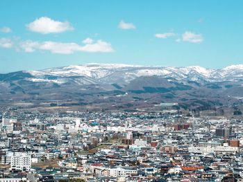 Aerial view of townscape against sky