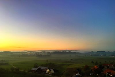 Scenic view of landscape against clear sky during sunset