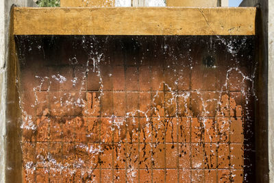 Close-up of flowing water against wall