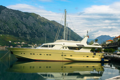 Motor yacht moored in the bay. in the background of the mountain and the blue sky with clouds