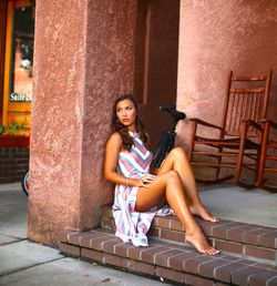 Portrait of young woman sitting outdoors