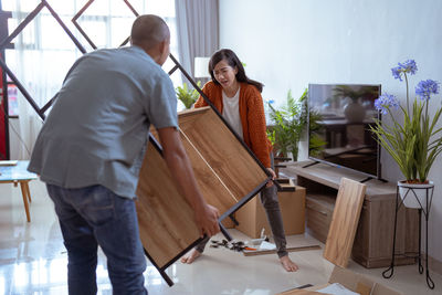 Side view of woman sitting on chair