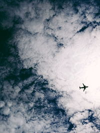 Low angle view of airplane flying in sky