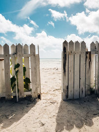 White fence and door leading to paradise sandy beach. sea, vacation, no people.