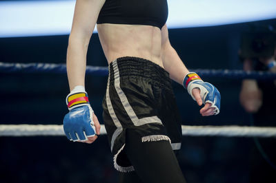 Midsection of boxer standing in boxing ring