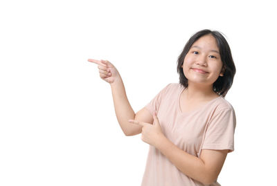 Portrait of young woman gesturing against white background