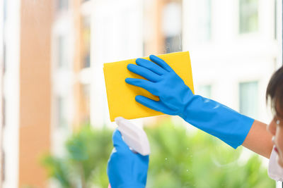 Woman cleaning glass window