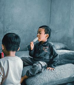 Boys sitting on wall