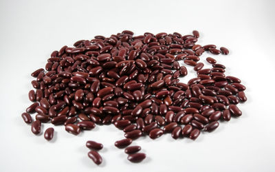 Close-up of coffee beans over white background