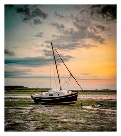 Sailboats in sea against sky during sunset