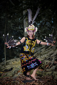 Portrait of young woman standing on rock