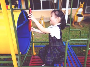 Side view of girl playing in playground