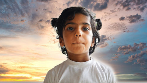 Portrait of young woman against sky during sunset