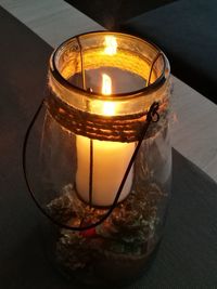 Close-up of lit tea light candle on table